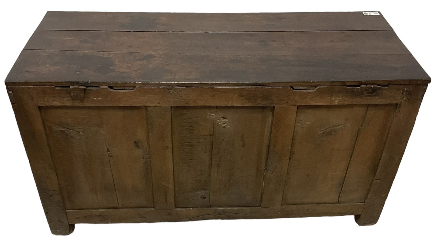 Large 18th century oak coffer or blanket box, hinged lid over triple panelled front, panelled back and sides, on stile supports 