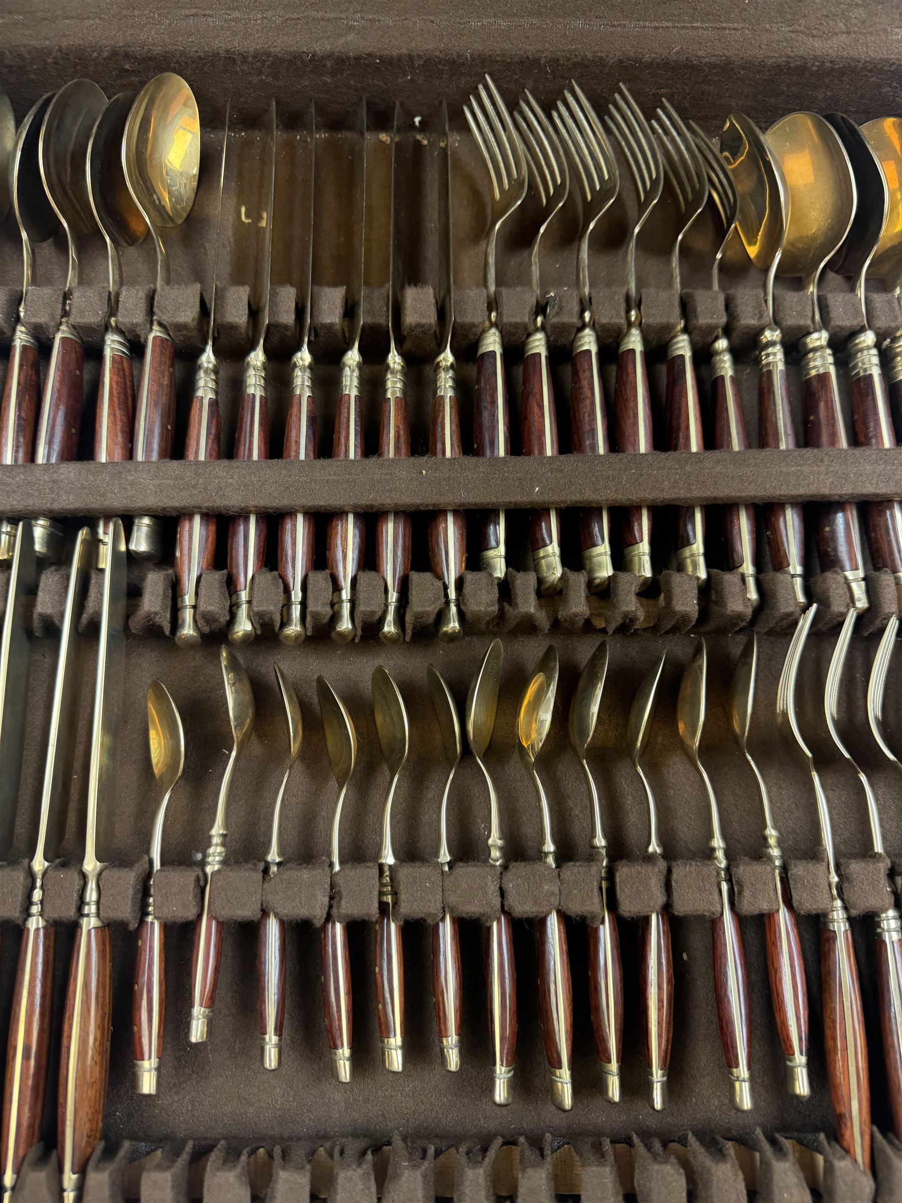 Wooden cased six place Thai gilt metal canteen of cutlery, together with additional matching flatware 