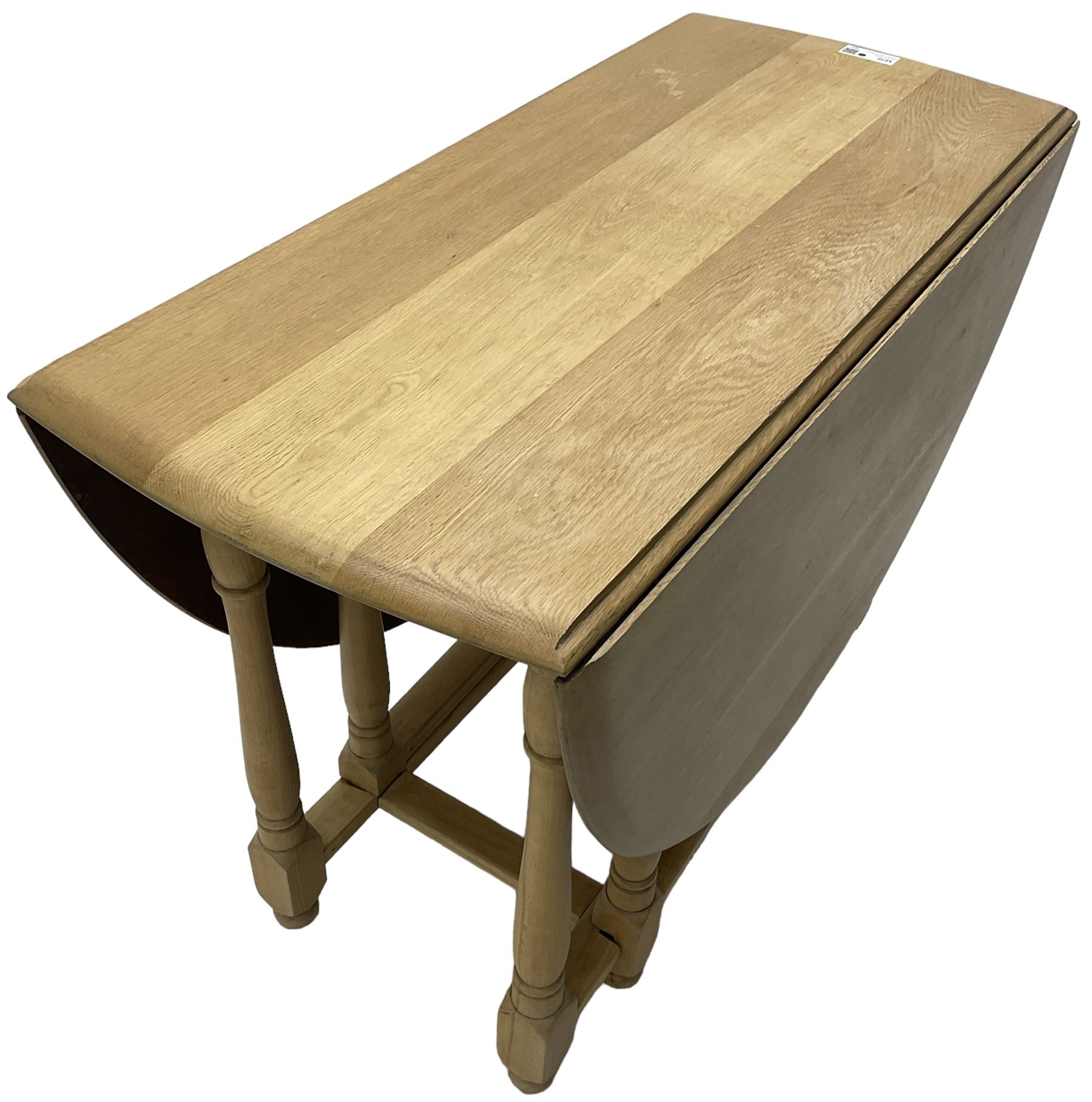 Contemporary oak and beech dining table, oval drop-leaf top on turned supports united by stretchers, gate-leg action base