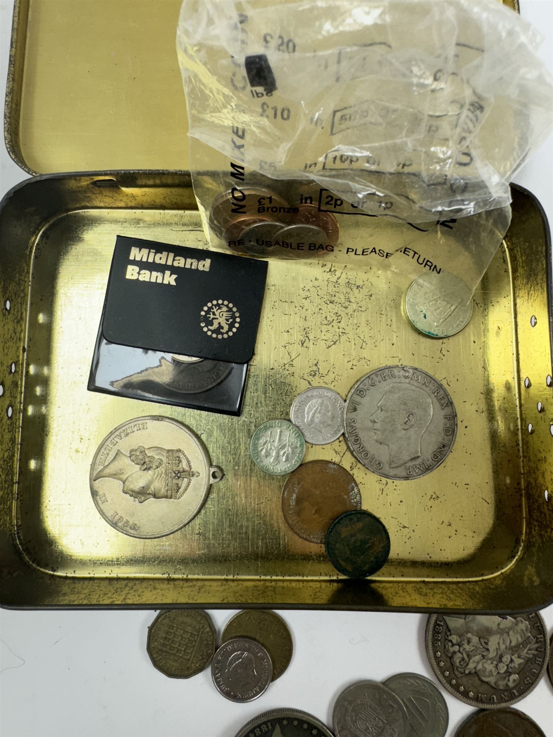 Various coins and banknotes including two Morgan dollars, in a vintage tin