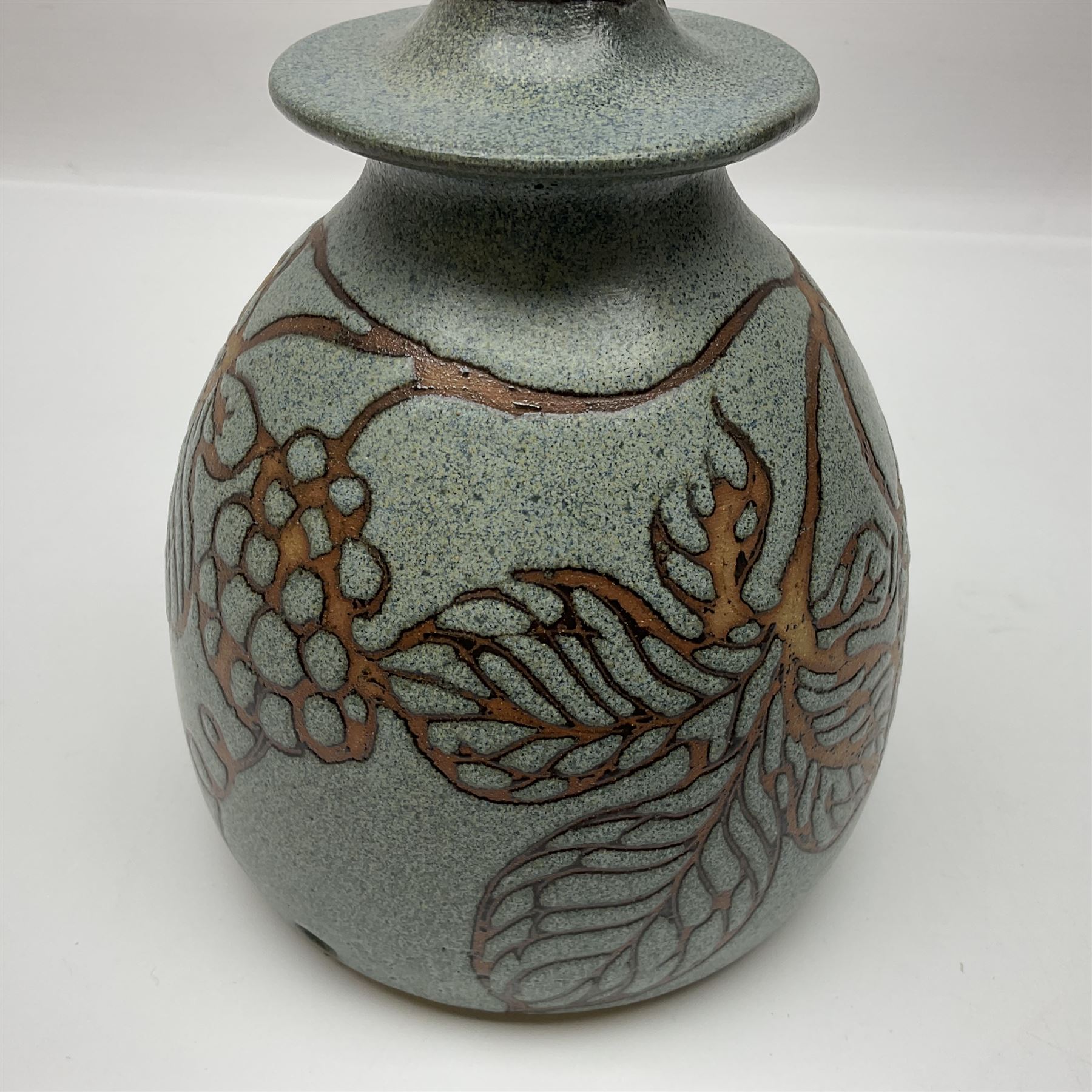 John Egerton (c1945-): studio pottery stoneware, comprising wine cooler decorated with herons on a mottled ground, covered storage jar with foliage decoration and a lamp base decorated with grape vines, wine cooler H23cm