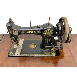 Early 20th century Jones treadle sewing machine table, bevel edged rectangular top with hinged lid enclosing sewing machine no. 480760, supported by cast iron treadle base