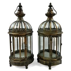 Pair of patinated brushed brass lanterns, of domed hexagonal form, with pierced gallery and swing handle, H63cm 


