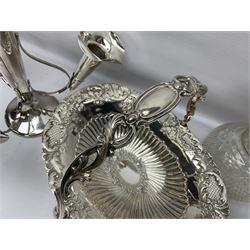 Silver plated three branch epergne, together with a silver plated cut glass claret jug, and silver plated embossed swing handled basket, epergne H30.5cm