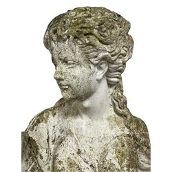 Weathered and painted cast stone garden statue, in the form of an Italian maiden carrying baskets with gathered flora and berries, on a shaped ovoid base