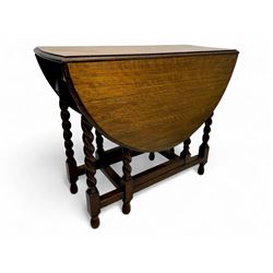 Early 20th century oak gateleg table, oval top with drop leaves supported by barley twist ...