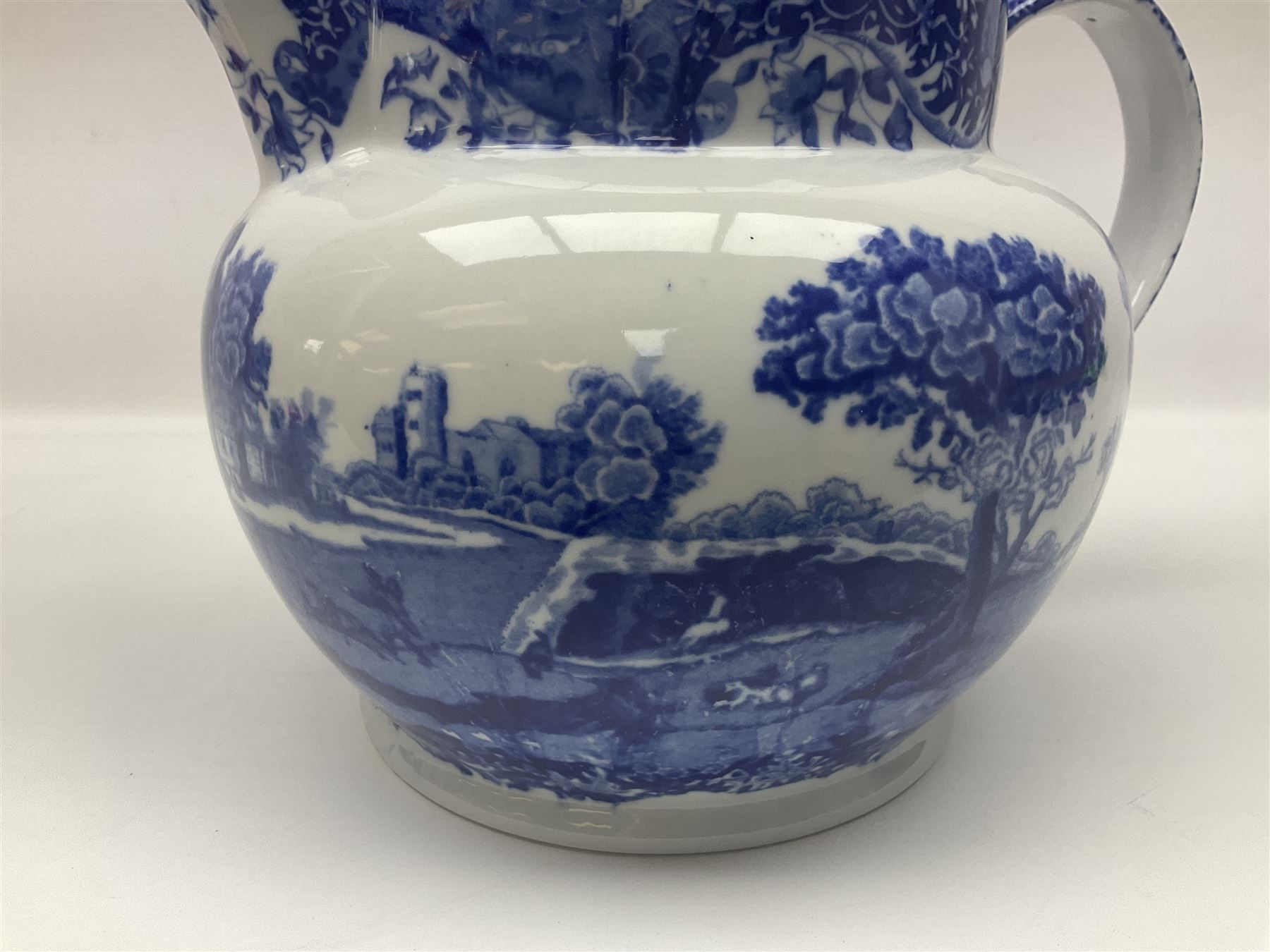 Large blue and white jug, decorated with landscape transfer print, H24cm