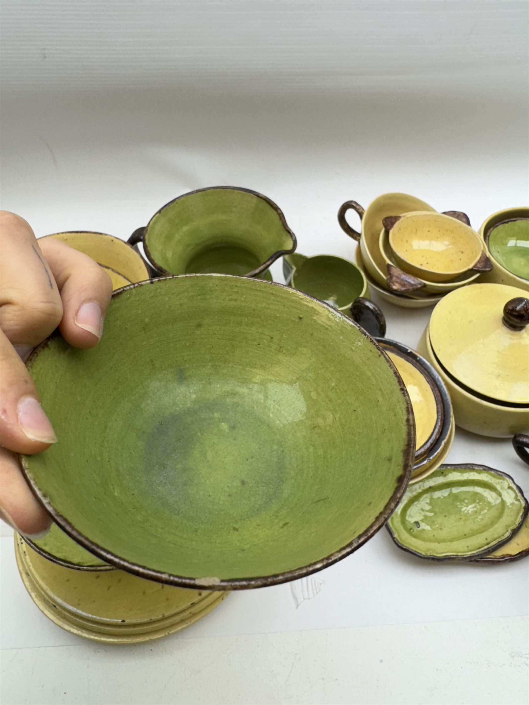 French green and yellow glazed tea and dinner wares by Etienne Noel, including milk jugs, teacups, side plates, bowls etc (43)