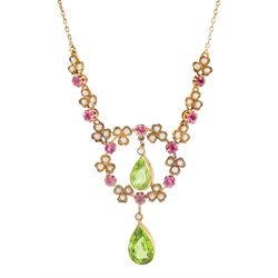 Early 20th century 15ct gold peridot, pink tourmaline and seed pearl necklace, two pear cut peridot drops, suspending from circular floral deign pendant, set with round cut tourmalines and seed pearls, to three further floral clusters and two tourmalines set either side, on trace link chain necklace, stamped 15c