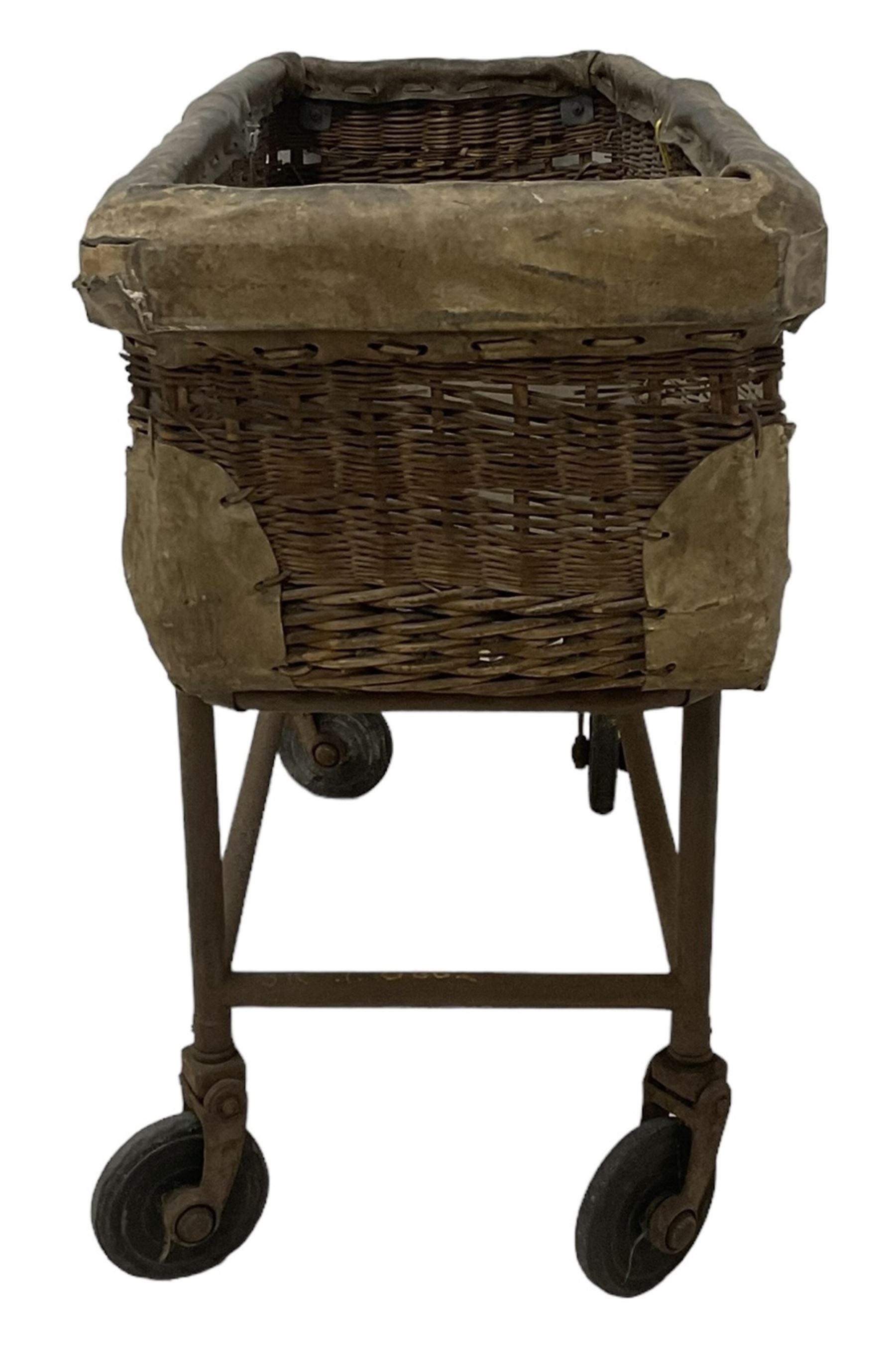 Early 20th century GPO wicker and hide bound postal trolley, on a cast iron base with castors