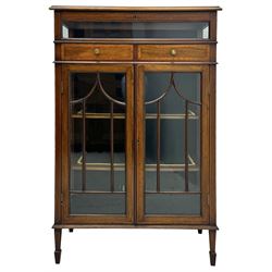 Edwardian mahogany bijouterie display cabinet, featuring satinwood inlay and crossbanding, hinged glazed top fitted with two banded drawers, over two astragal glazed doors enclosing black wool baize lined shelves with gold trim, supported by spade feet