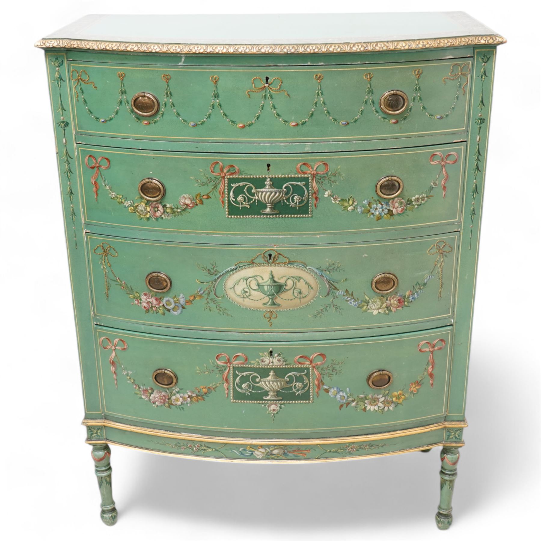 Edwardian Adam Revival green-painted and parcel gilt bowfront chest, moulded and foliate carved top painted with trailing floral band, fitted with four drawers decorated with trailing floral festoons, ribbon ties and urns, oval handle plates with engraved decoration and bead cast handles, on turned supports decorated with acanthus leaves and draped festoons 