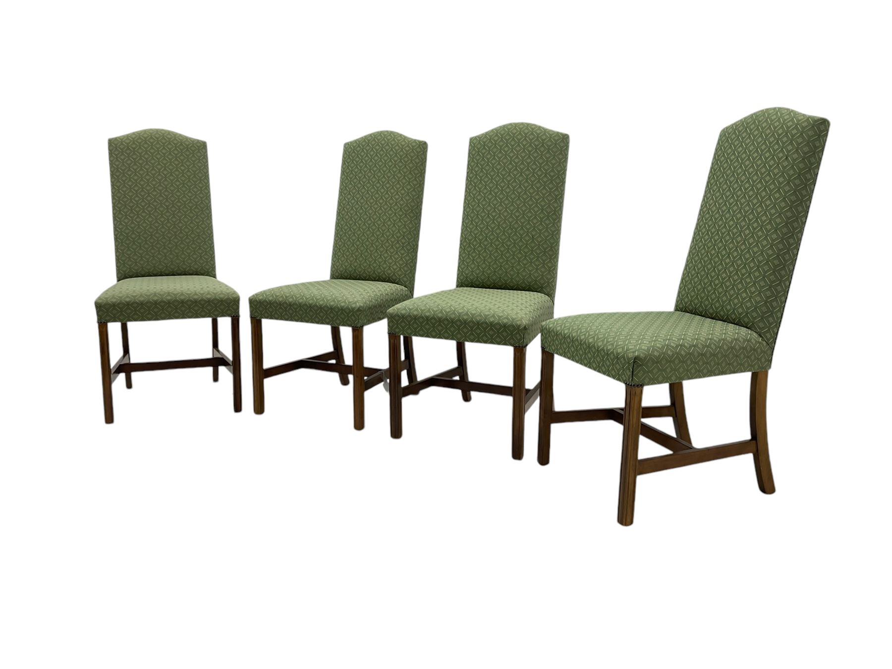 Early 20th century oak extending dining table, rectangular top with rounded corners, on turned baluster supports united by X-stretchers, fitted with a pull-out extending mechanism (106 x 142 - 228cm, H76cm); set of eight high-back dining chairs upholstered in green fabric with geometric diamond pattern