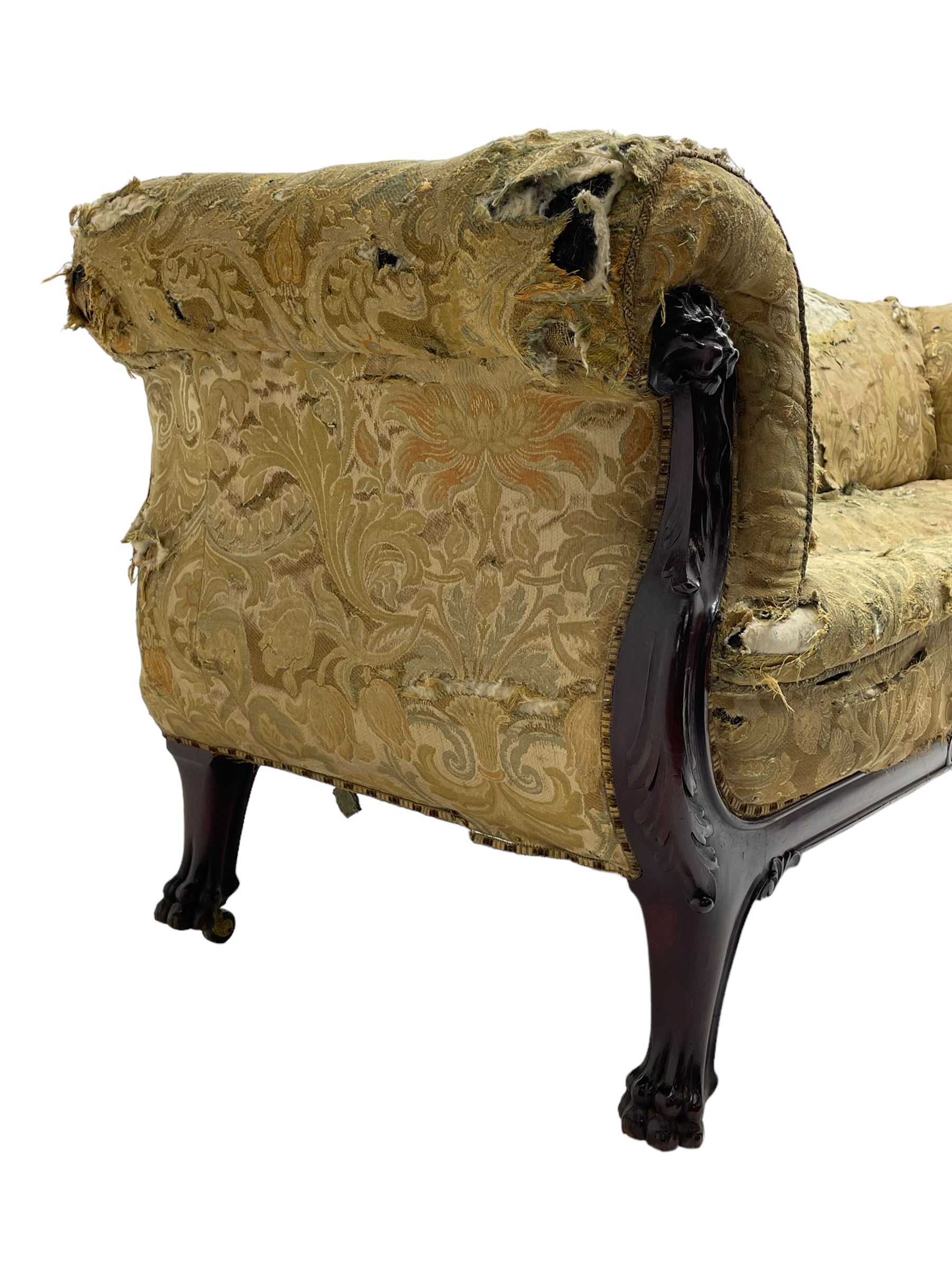 19th century mahogany settee, rolled S-scrolled arms carved with lion masks and acanthus leaf scrolls, the lower moulded rail carved with scrolling design, raised on carved paw feet with recessed brass and ceramic castors 