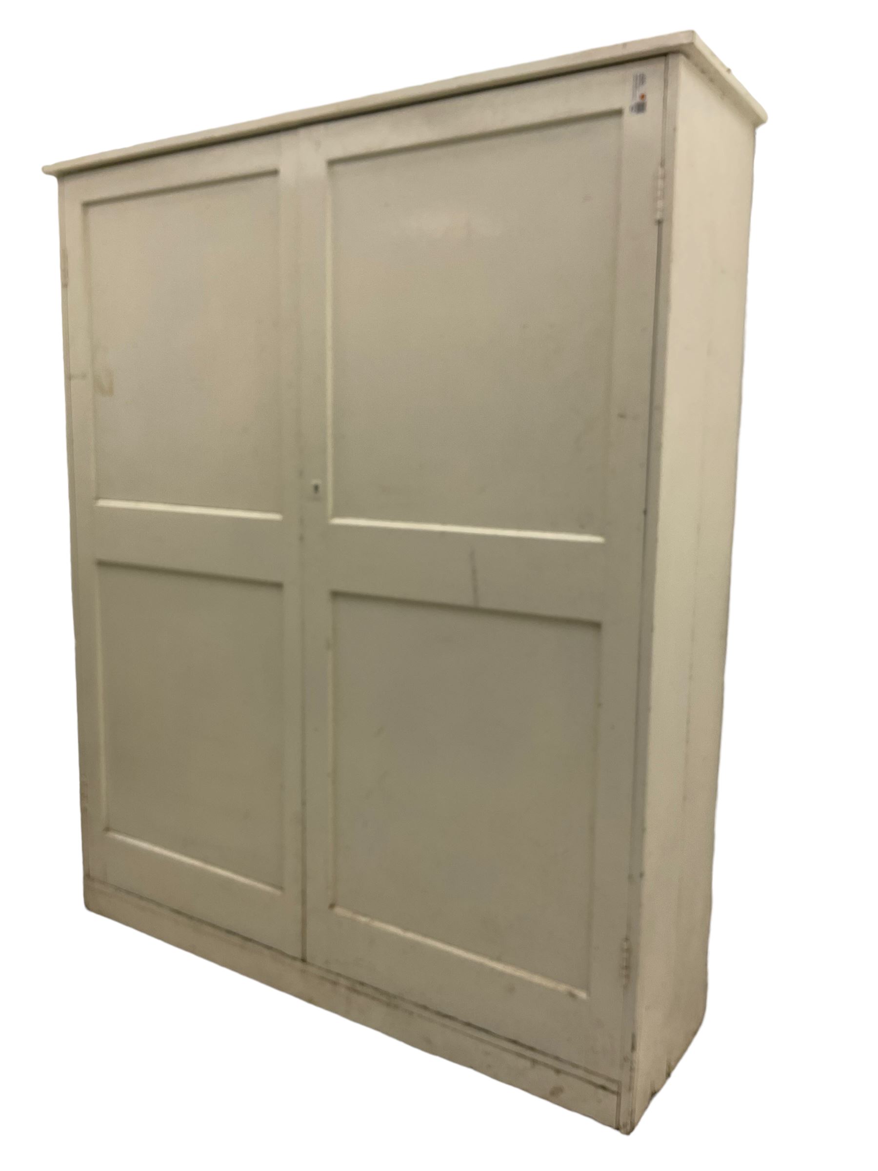 Large Victorian white painted pine cupboard, enclosed by two panelled doors 