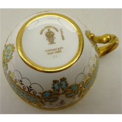  Royal Crown Derby tea cup and saucer from the Judge Elbert Henry Gary service, circa 1910, hand painted by Albert Gregory, signed, with baskets of flowers in cartouche shaped panels on cobalt blue and turquoise ground with raised gilded border incorporating an oval medallion with the initial 'G' by George Darlington, signed, printed back stamp in gilt with Royal Warrant and Tiffany & Co retailer's mark, saucer D14cm cup D8cm (2) Provenance Property of Bob Heath, Brandesburton Formerly of Ravenfield Hall Farm near Rotherham  