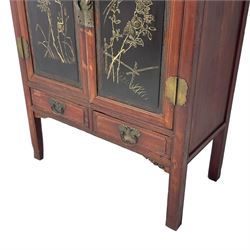 Late 19th century Chinese Qing dynasty red and black lacquered wood cabinet, Fujianese province, upper cupboard enclosed by two doors with relief carved and gilt panels depicting figures behind glass, the large cupboard enclosed by two panelled doors carved with trailing foliate branches and birds, inscribed with Chinese characters, to the left ‘Prolong life’ and to the right ‘Wealth and good fortune’, fitted with two drawers, square supports with carved brackets 