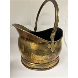 Middle eastern copper bucket, with chased and embossed band of animal decoration, together with a copper jardinière embossed with floral panels, copper plate with embossed leaf motif and two brass helmet shaped coal scuttles, bucket H26cm