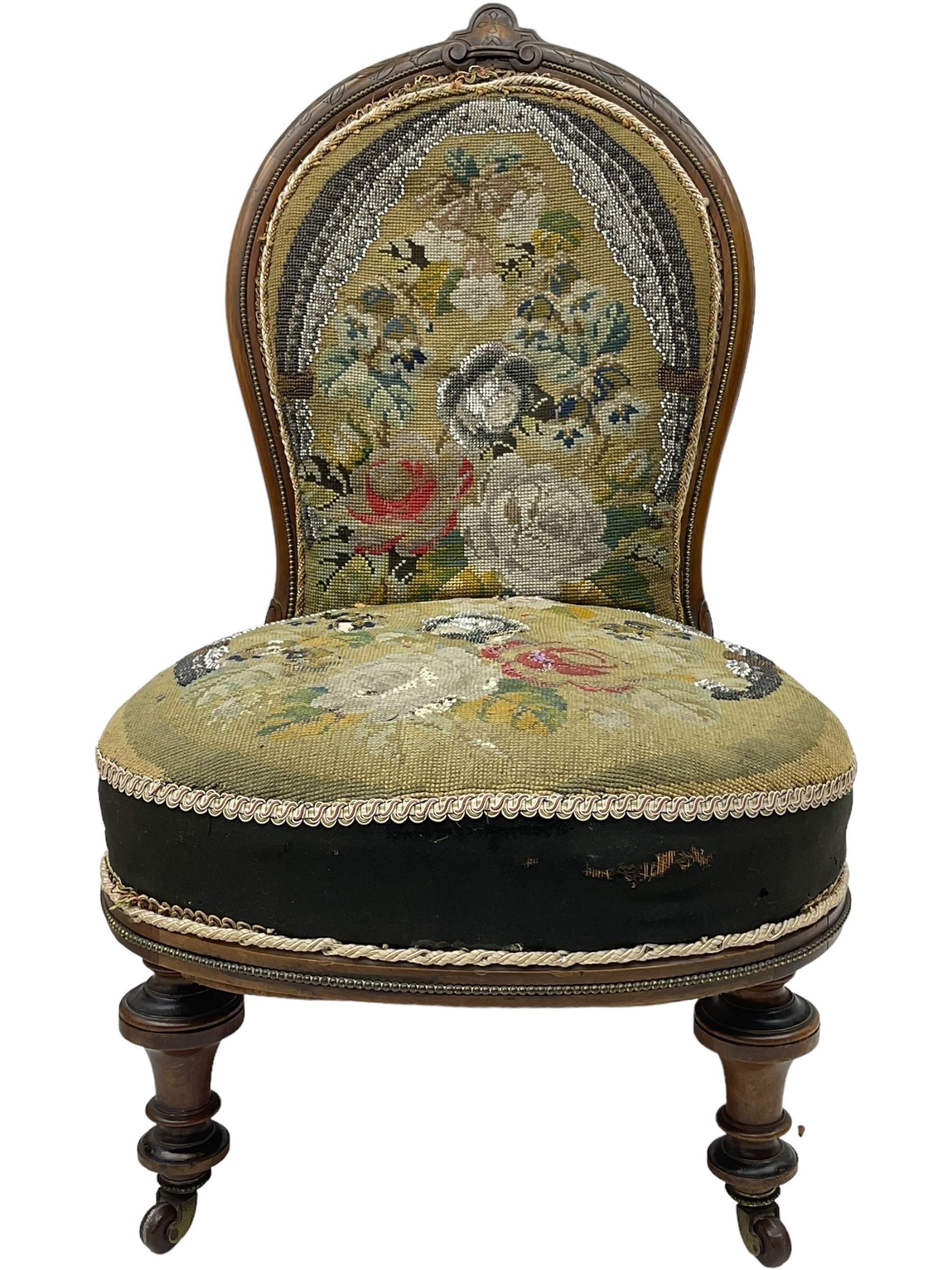 Early 20th century mahogany side chair, detailed marquetry frame, backrest with central urn motif and scrollwork inlay, arched crest rail with floral designs, cream and gold patterned fabric seat, turned front legs with brass castors (H78cm); Victorian walnut nursing chair, carved crest rail, floral needlepoint tapestry upholstery, turned front legs with ceramic castors (H81cm)