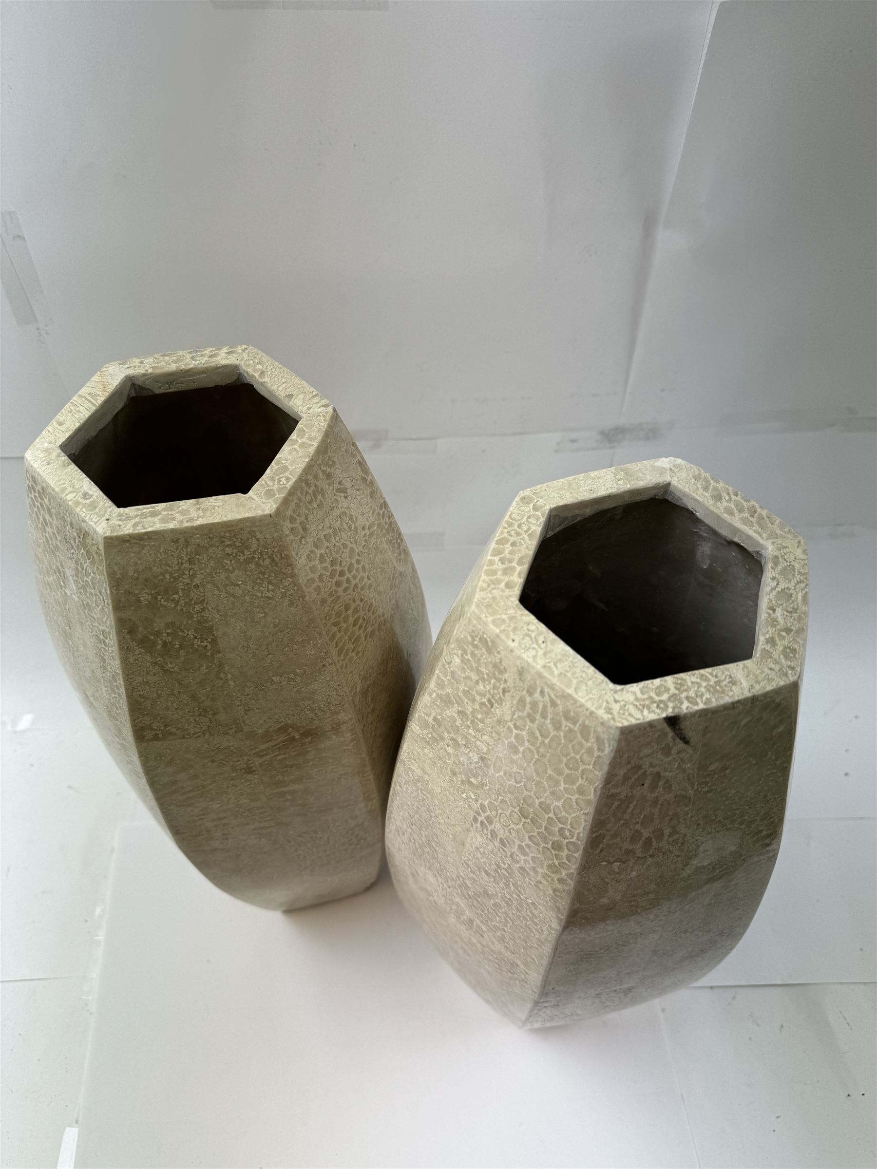 Pair of fossilised coral mosaic vases, of hexagonal form, H46cm