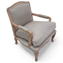 Louis XV design limed hardwood framed open armchair, upholstered in pale taupe fabric with loose seat cushion, raised on cabriole supports with scroll feet