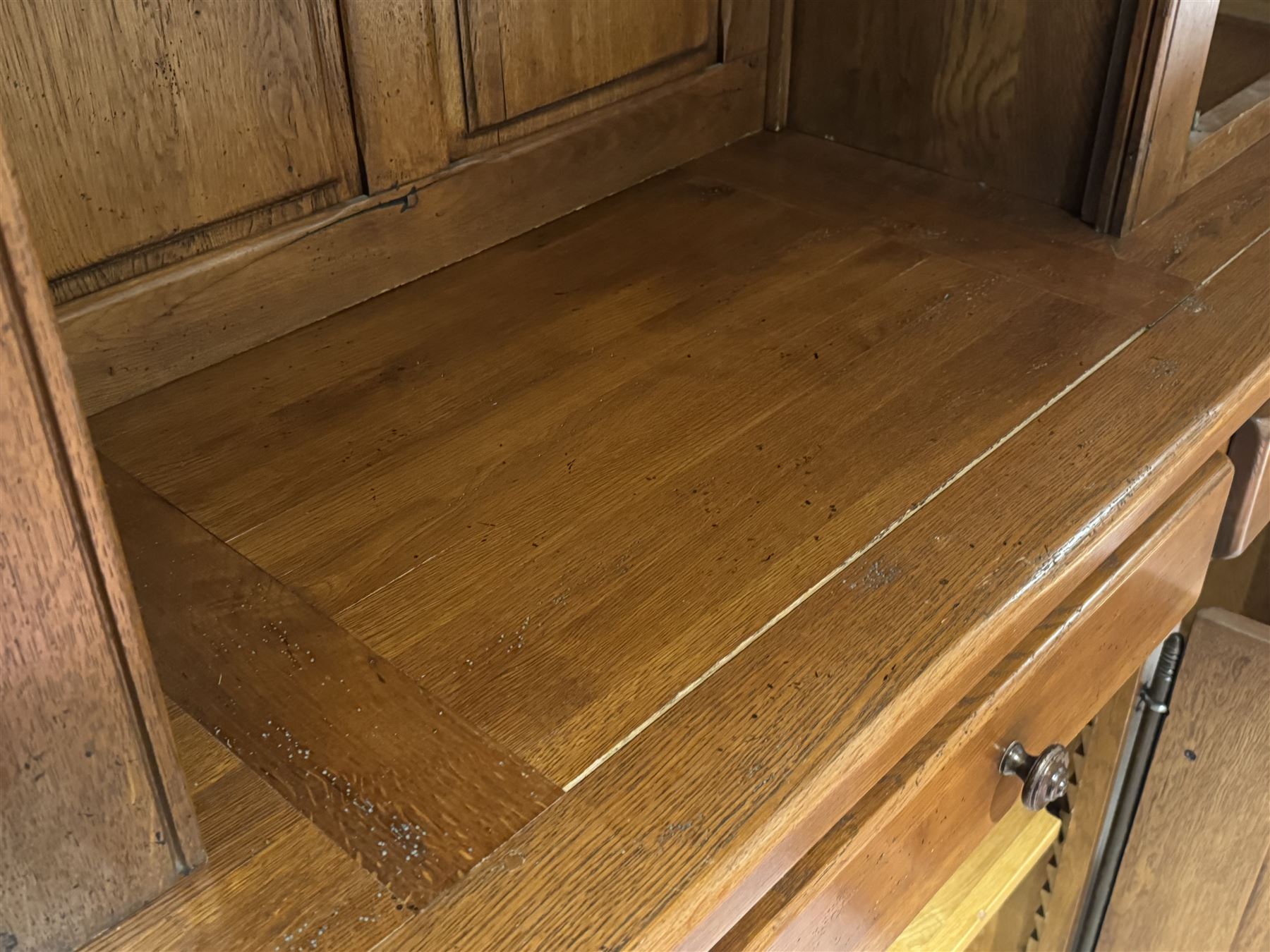 Large 20th century oak dresser, projecting cornice over open arched central section with two shelves, flanked by two panelled cupboards with two shelves, lower section with three drawers above three cupboards, on stile supports 