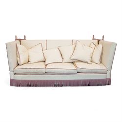 Grande Knole four-seat sofa, upholstered in geometric lozenge pattern cream fabric with burgundy and cream twist piping and fringe, on castors