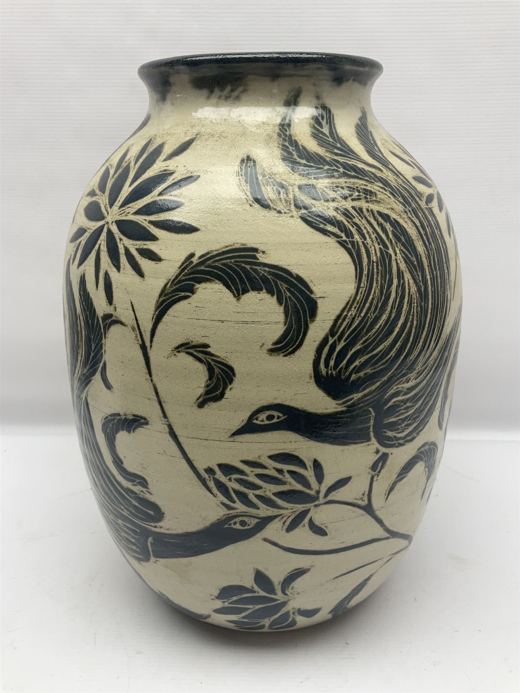 John Egerton (c1945-): studio pottery stoneware vase decorated with birds in flowers braches upon a white ground, H40cm