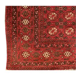 Antique Persian crimson ground rug, the field decorated with Gul motifs, the guarder border with stylised stars in ivory and dark indigo