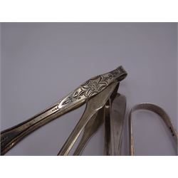 Four pairs of silver sugar tongs, to include three George III pairs comprising a bright cut engraved example, hallmarked Peter, Ann & William Bateman, London 1801, a fiddle pattern example, with engraved initials, hallmarked Thomas Wallis II, London 1806 and one other, hallmarked Stephen Adams II, London 1800, together with an Edwardian pair, with shell bowls, hallmarked Mappin & Webb Ltd, Sheffield 1909