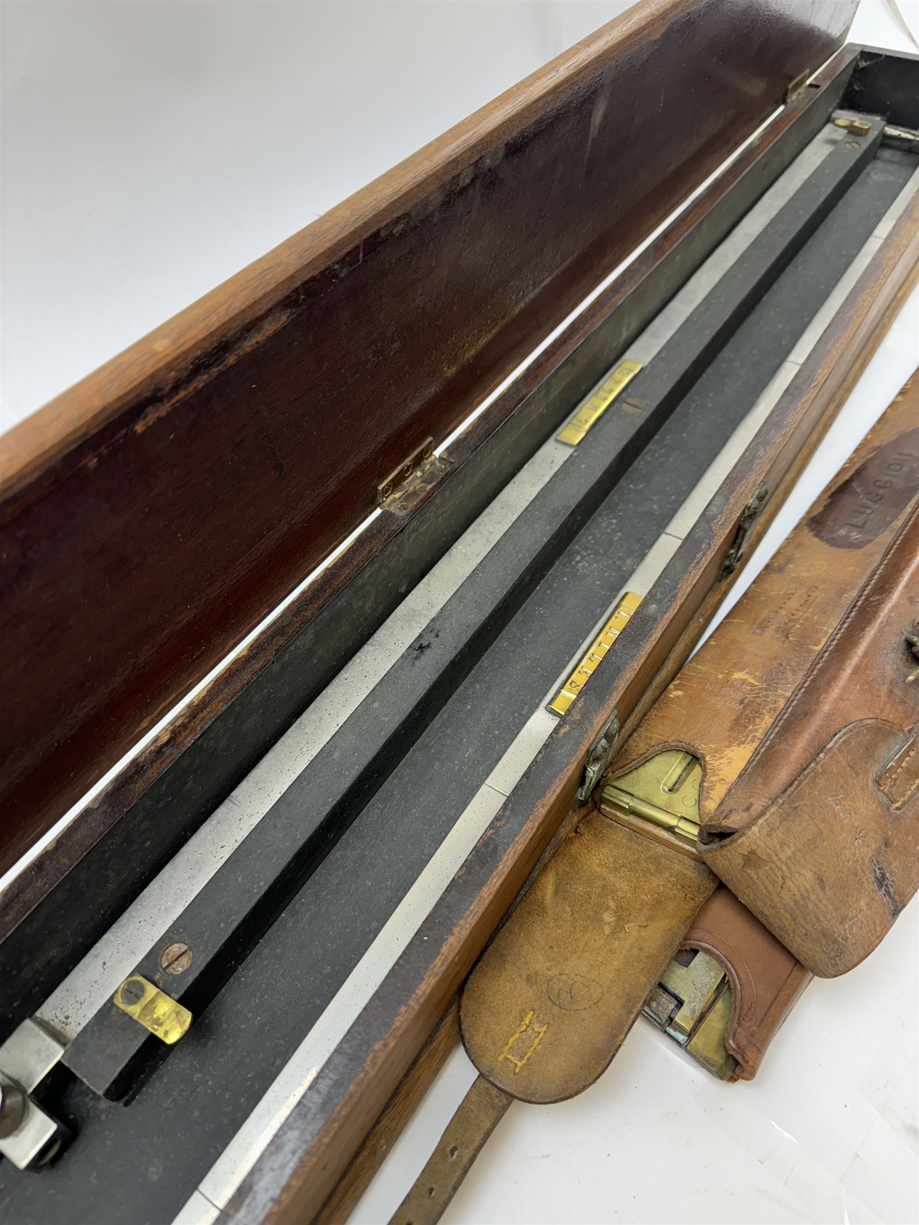 Early 20th century drawing instruments, to include a boxed set of large compasses, possibly for map drawing, marked 5, 6 and 7 miles, in fitted wooden case, together with two rules marked W. Harling and a parallel rule stamped R. E & Co MK II, all with broad arrow mark, contained within leather cases