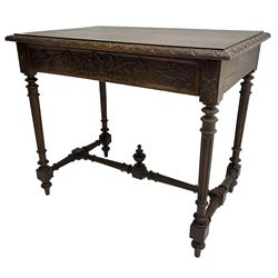 19th century walnut side table,  rectangular top with lunette carved moulded edge, the frieze drawer carved with ribbon and extending vine branch and grapes, on turned and fluted supports united by fluted stretcher with centre finial 