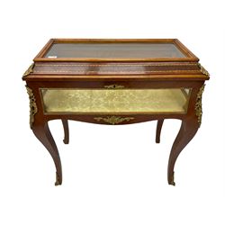 Mid-to-late 20th century French design Kingwood and walnut bijouterie cabinet, enclosed by cavetto moulded hinged lid with gilt metal foliage cast mounts and checkered stringing, on cabriole supports mounted by ornate cartouche castings and scrolled foliate terminal caps, lined in gold foliate pattern fabric and glazed with bevelled glass