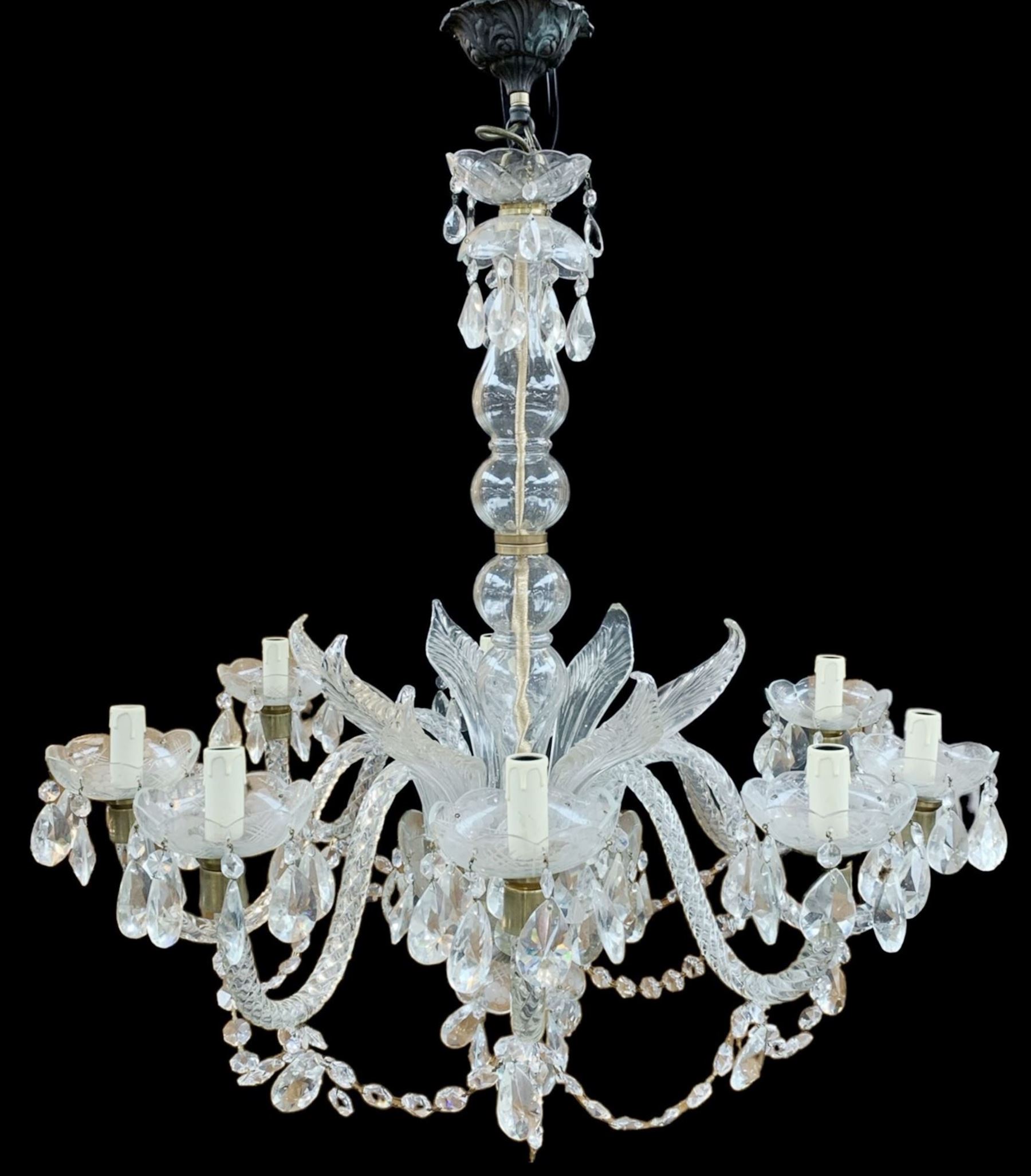 Italian style eight branch glass chandelier, with baluster stem, eight barley twist scroll arms interspersed by seven clear blown glass leaves, petal edged drip pans and hung with faceted glass bead swags and drops, H94cm x W85cm approx.