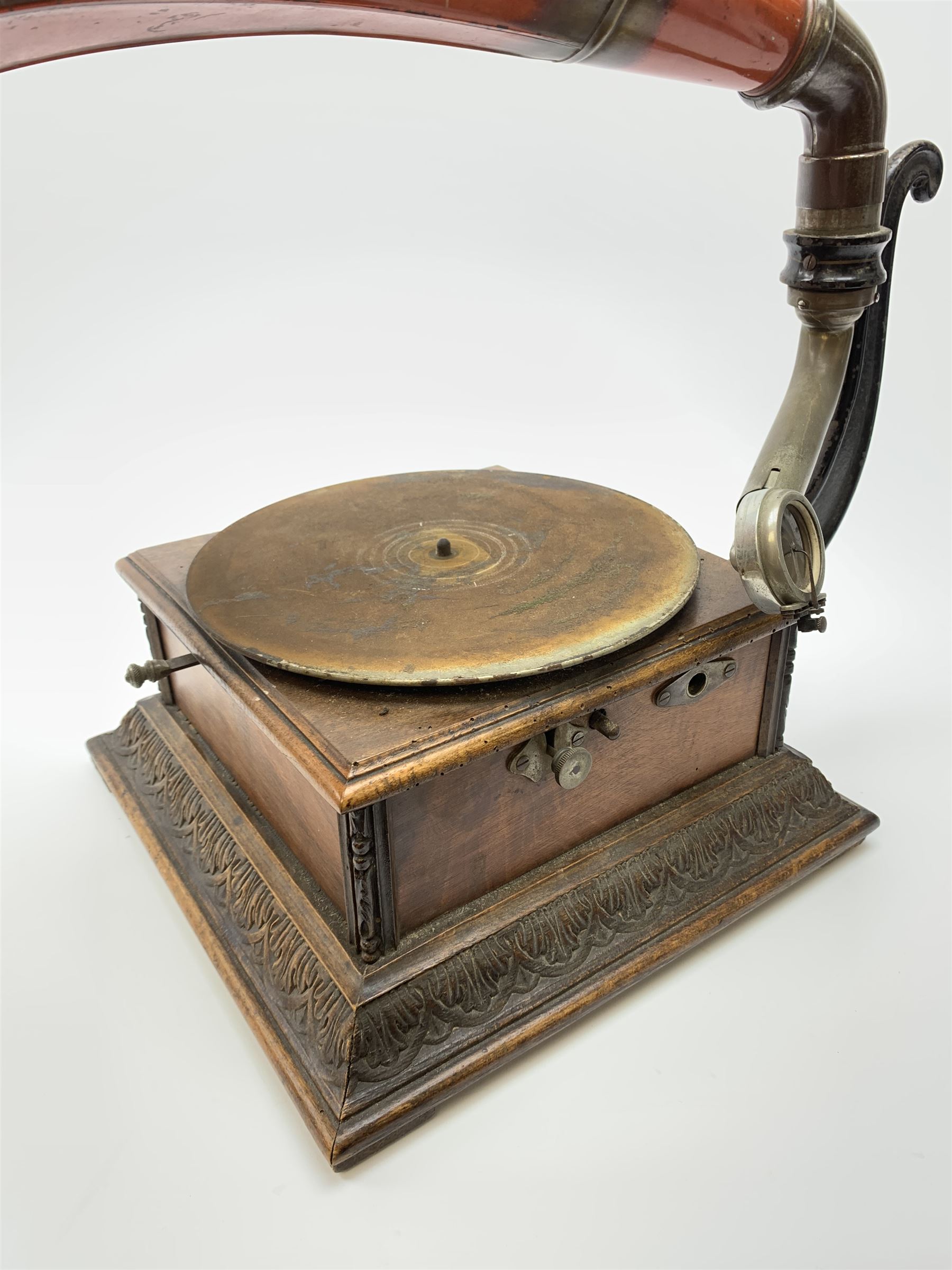 A wind up gramophone with red painted tin plate horn, upon a mahogany base, overall H71cm.