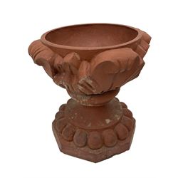 Pair of late 19th to early 20th century red terracotta garden urn planters, the shallow bowls moulded with curled acanthus leaf decoration, on circular foot with globular beaded moulding, octagonal base