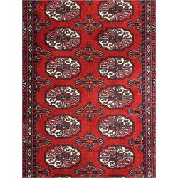 Persian Bokhara crimson ground runner rug, the field with a series of repeating ivory octagonal medallions, main border with repeating flower head pattern and diamonds within multiple guard stripes