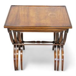 Regency design mahogany nest of three tables, rectangular top with raised lip on curved X-frame supports united by turned stretchers 