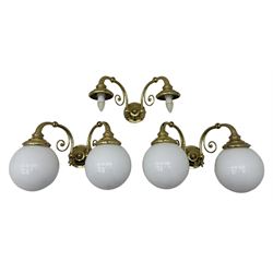 Two brass double-arm wall mounted lights, each with frosted glass globes and scrolled arms (W50cm, D26cm, H31cm); matching central double-arm light with candle-style fittings (W42cm, D24cm, H22cm)