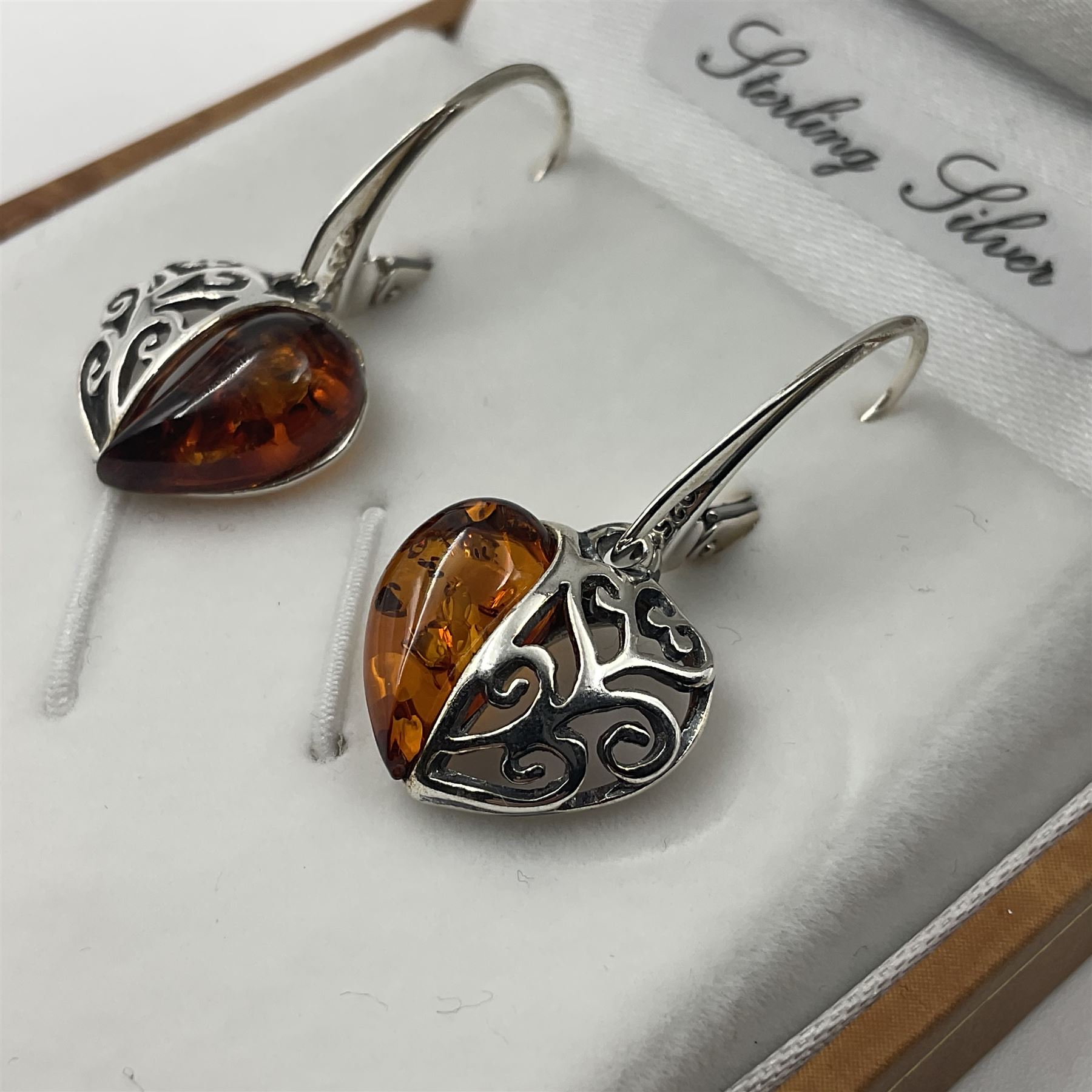 Pair of silver Baltic amber heart pendant earrings, stamped 925, boxed 