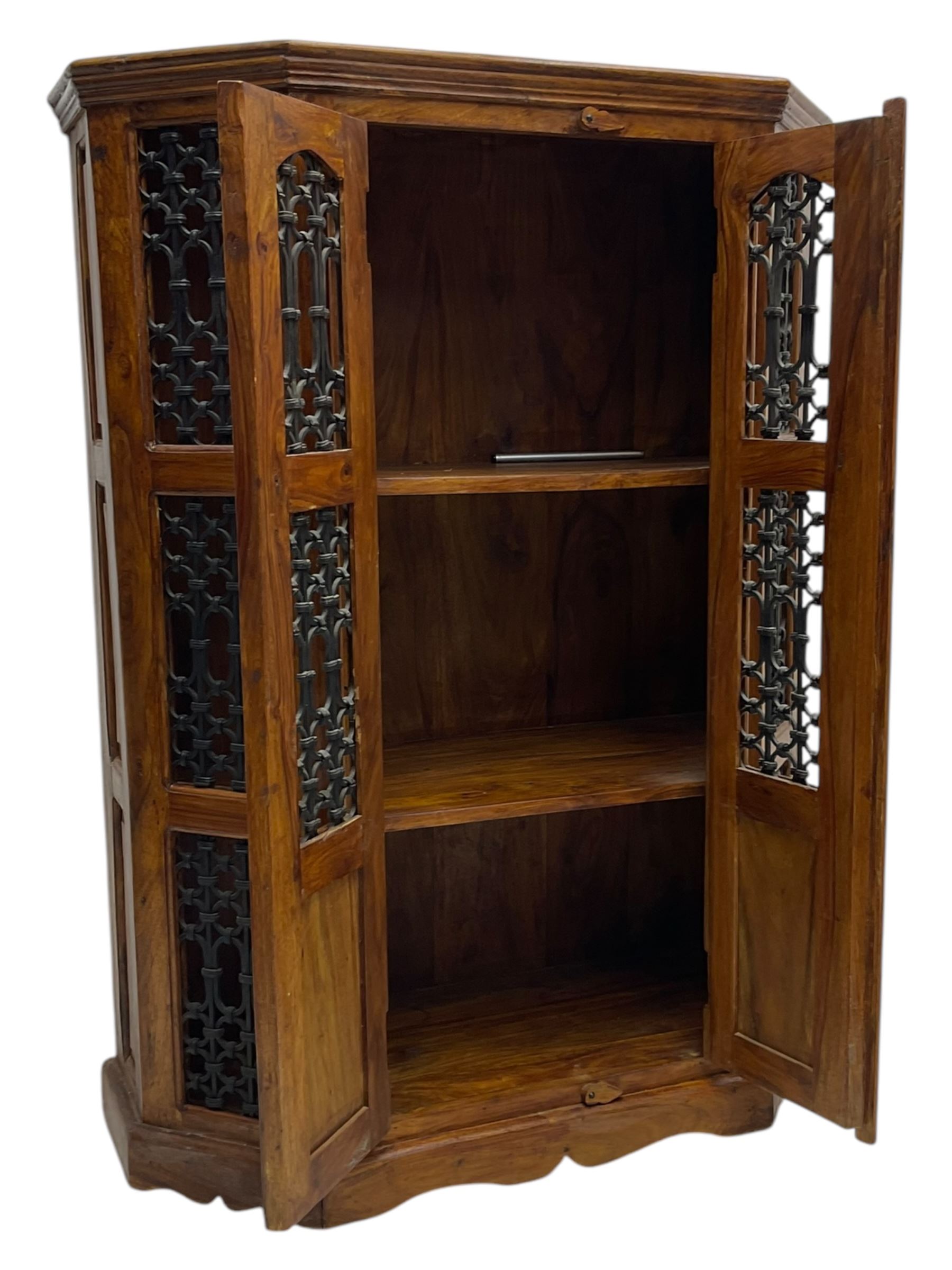 Hardwood and wrought iron cabinet, enclosed by two doors, on plinth base 