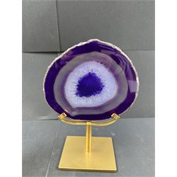 Pair of purple agate slices, polished with rough edges, raised upon gilt metal stands, H22cm