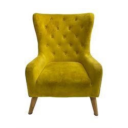 Mid-20th century design armchair, barrel back upholstered in buttoned mustard fabric, on tapering splayed front feet