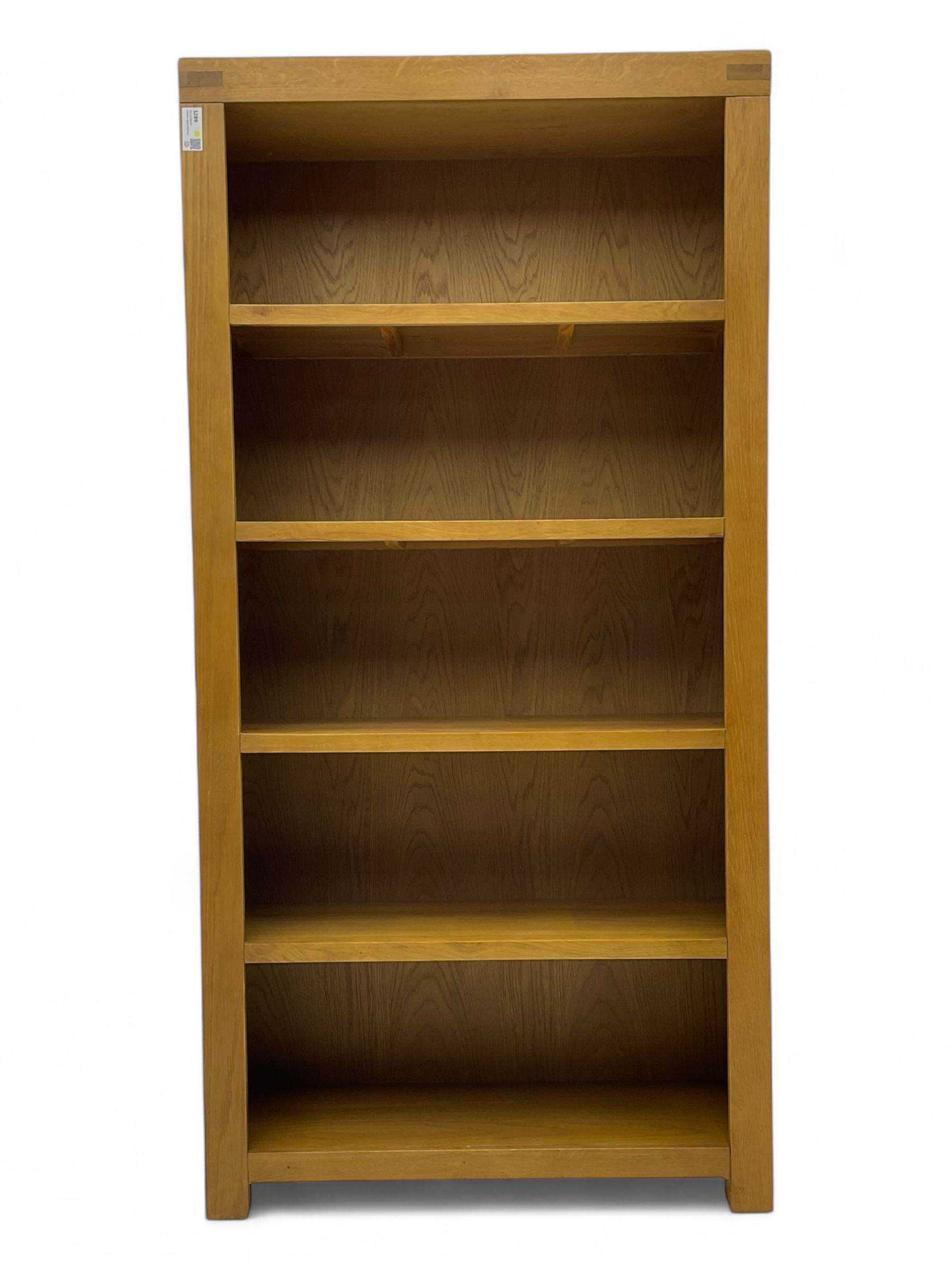 Light oak open bookcase fitted with four shelves 