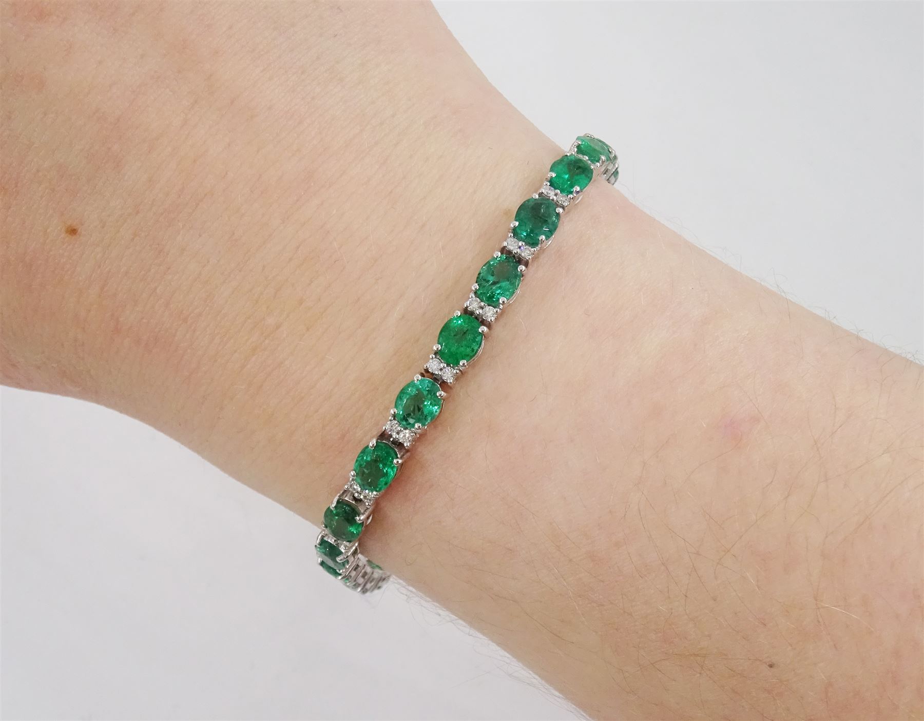 18ct white gold oval cut emerald and round brilliant cut diamond bracelet, stamped, total emerald weight approx 8.15 carat