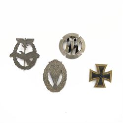 Four reproduction WWII German badges, including Iron Cross, German Proficiency SS runes badge, etc together with a reproduction German cap 