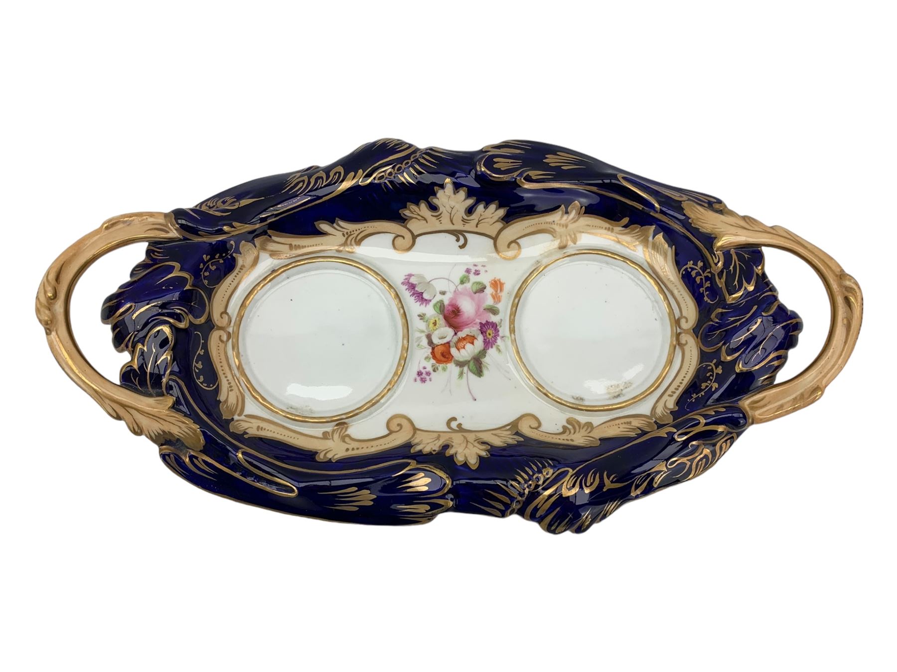 19th century porcelain inkstand, the oblong twin handled base centrally painted with a floral bouquet, flanked by two footed inkwells and covers, with rococo-inspired acanthus moulded borders and handles, pattern no. 2/3339, L26.5cm 