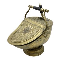 Victorian brass helmet shaped coal scuttle with embossed decoration and turned wooden handle and shovel, H49cm