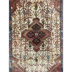 Small Persian rug, ivory and pale red ground, decorated with central medallion within a field of trailing Boteh motifs, geometric design guarded border