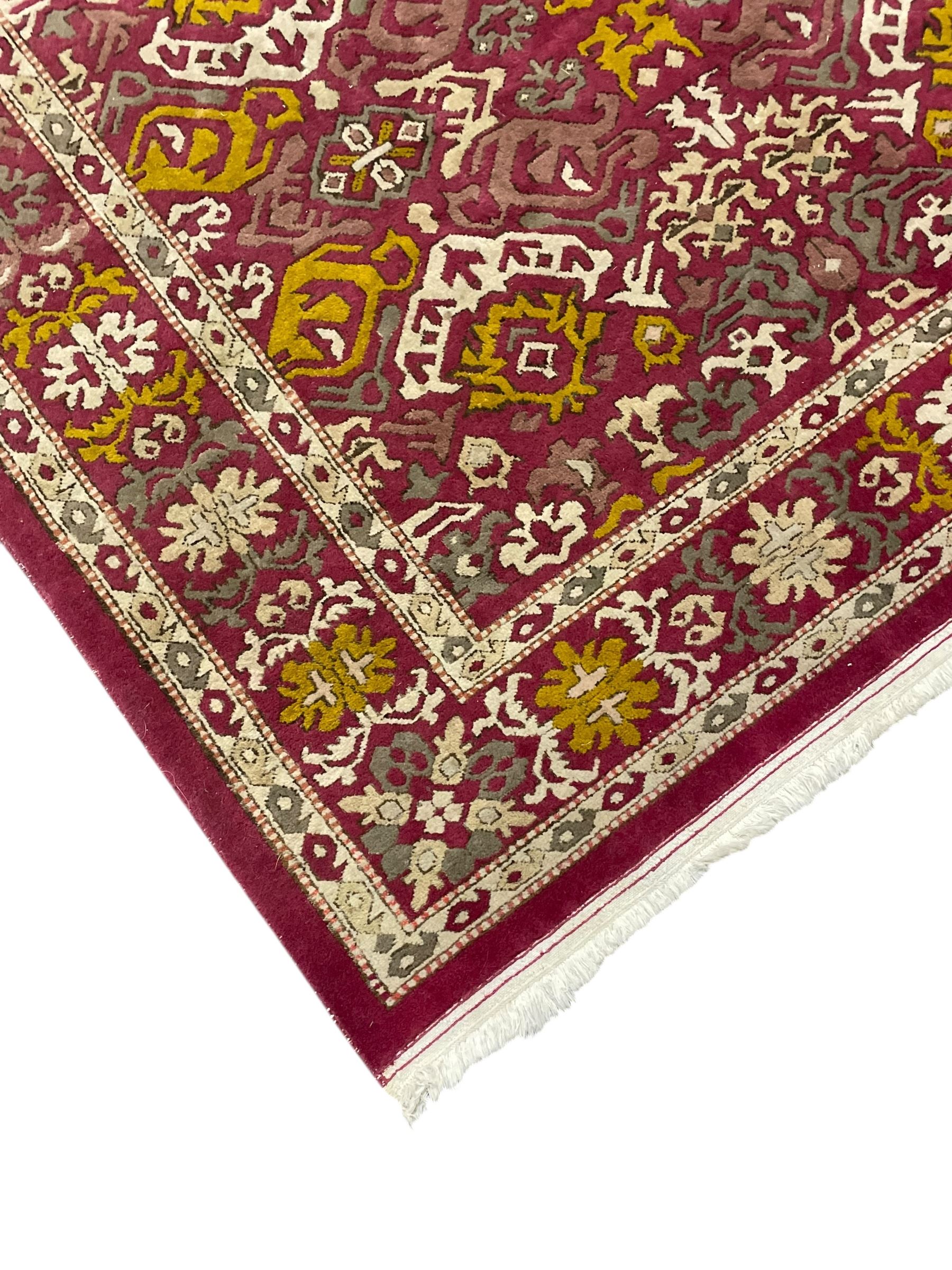 Persian design red ground rug, decorated with stylised plant motifs, repeating border within Boteh decorated guard stripes 